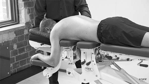 Image of a patient lying face down on a manipulation table